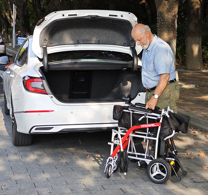 White folding electric wheelchair.  Mobile mobility scooter 24V / 650W 30km / h folding travel portable portable mobility scooter, mid-sized motorcycle